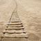 Foto einer Strickleiter im Sand