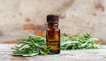 Rosmarin und braune Schraubflasche